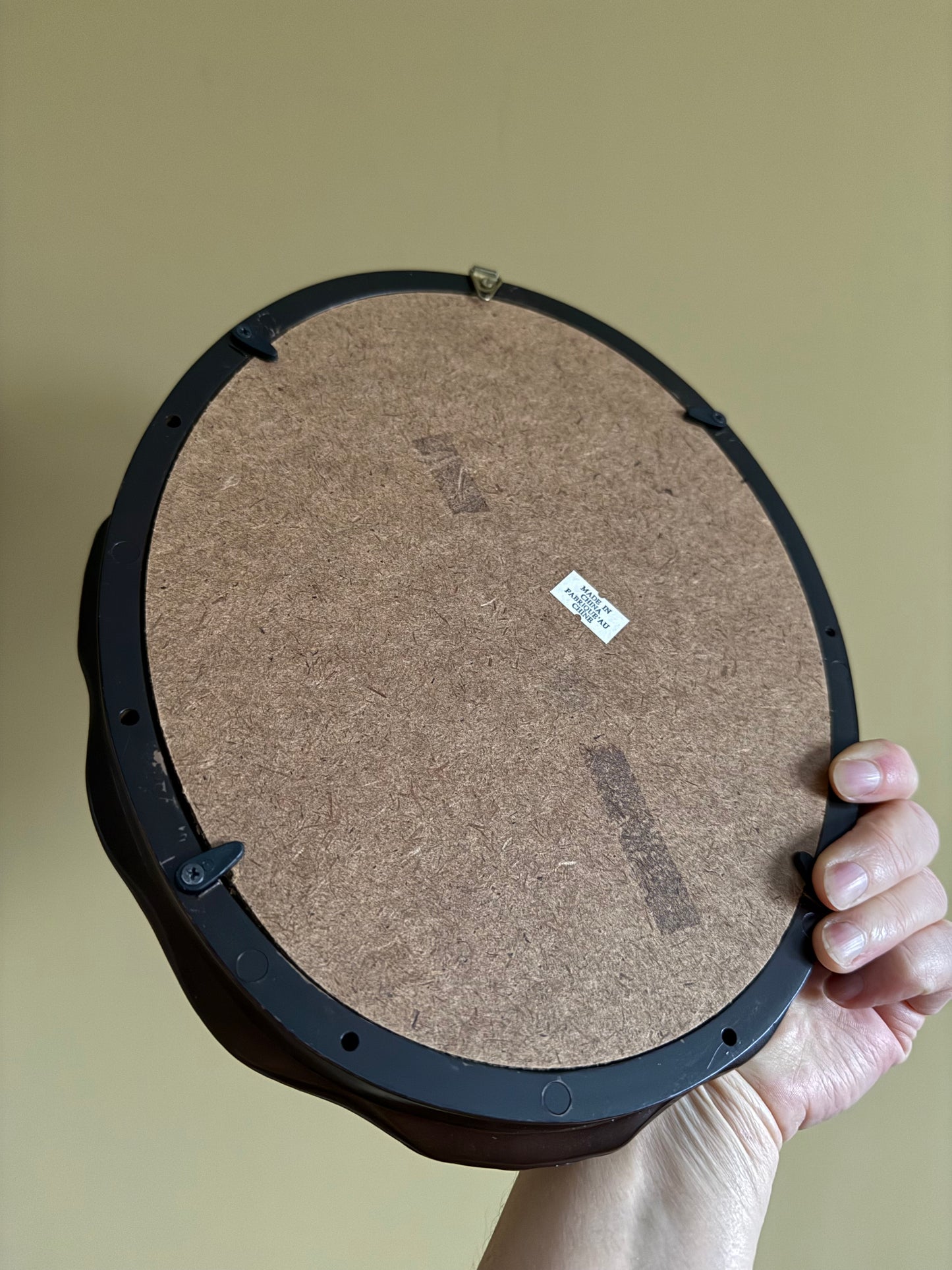 Vintage, oval plastic frame.