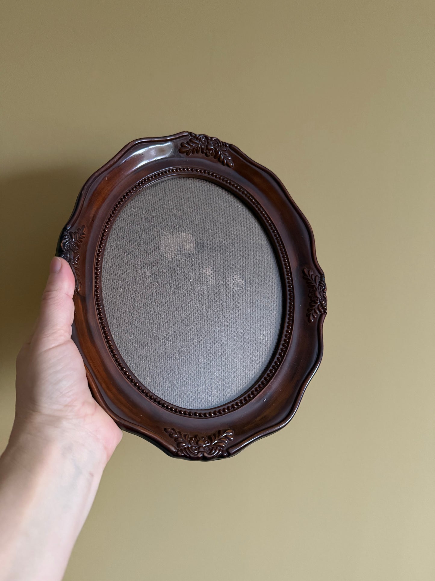 Vintage, oval plastic frame.
