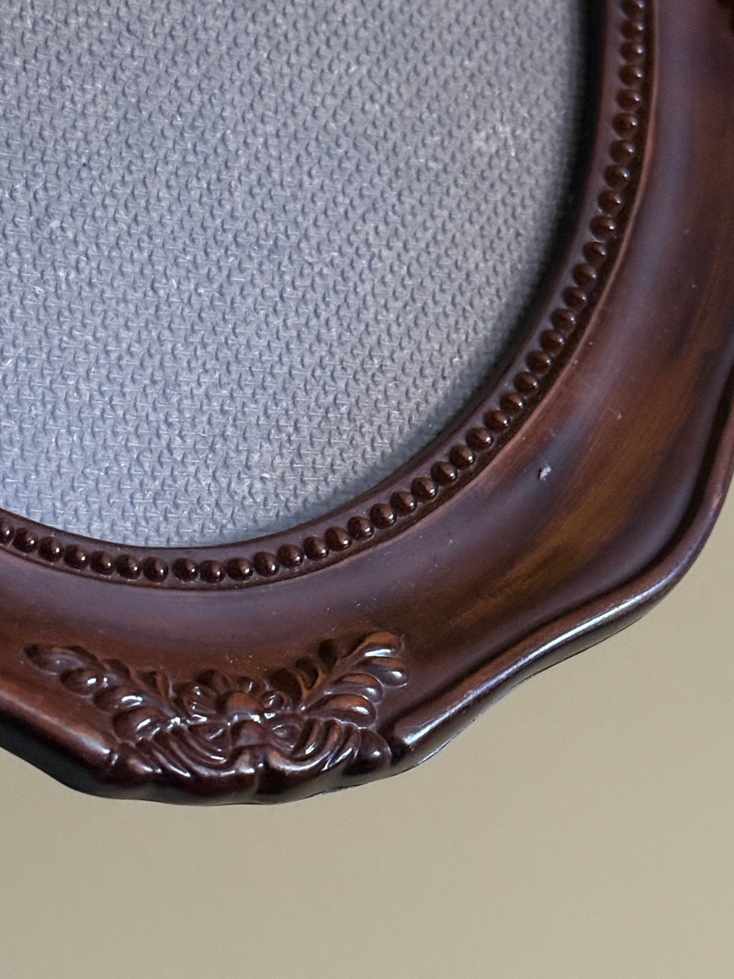Vintage, oval plastic frame.