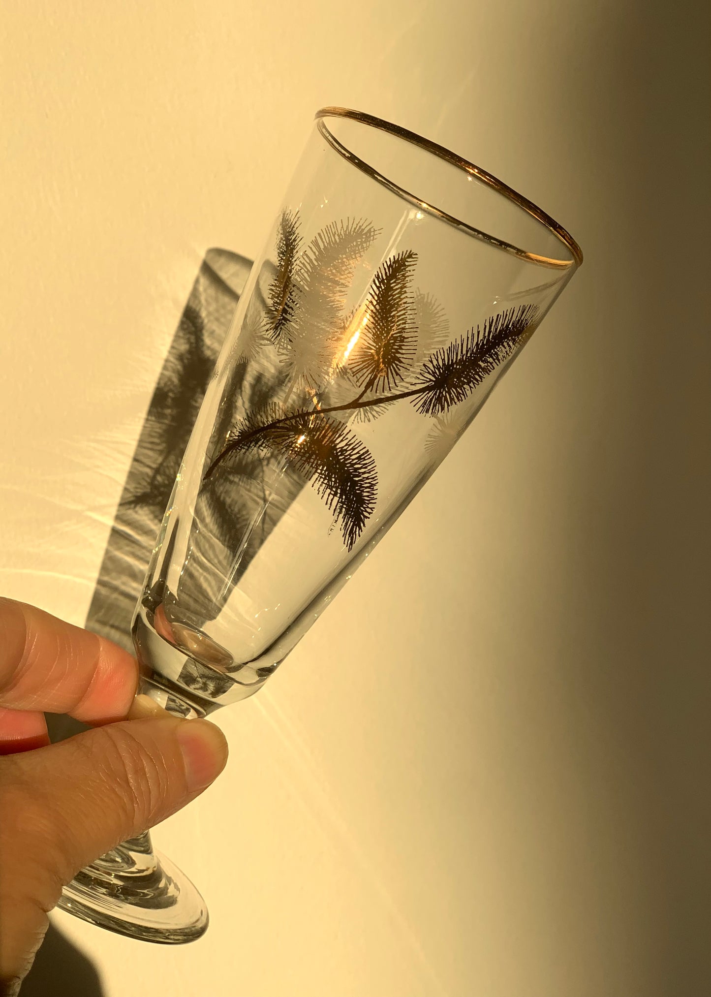 Vintage, gold feather stemmed glasses.