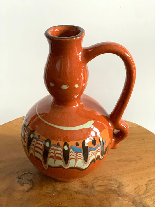 Vintage, handmade decorative terracotta bottle.