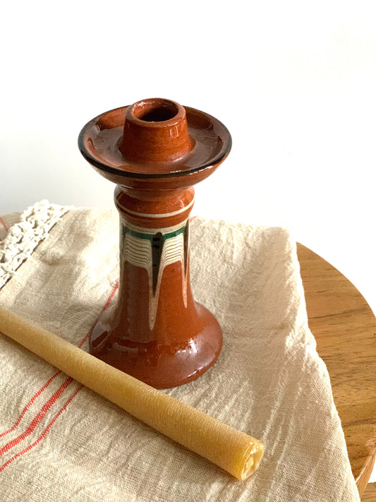 Vintage, handmade and hand painted terracotta candlestick.