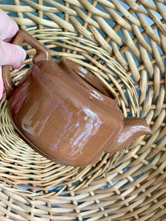 Single, vintage, handmade terracotta teapot.