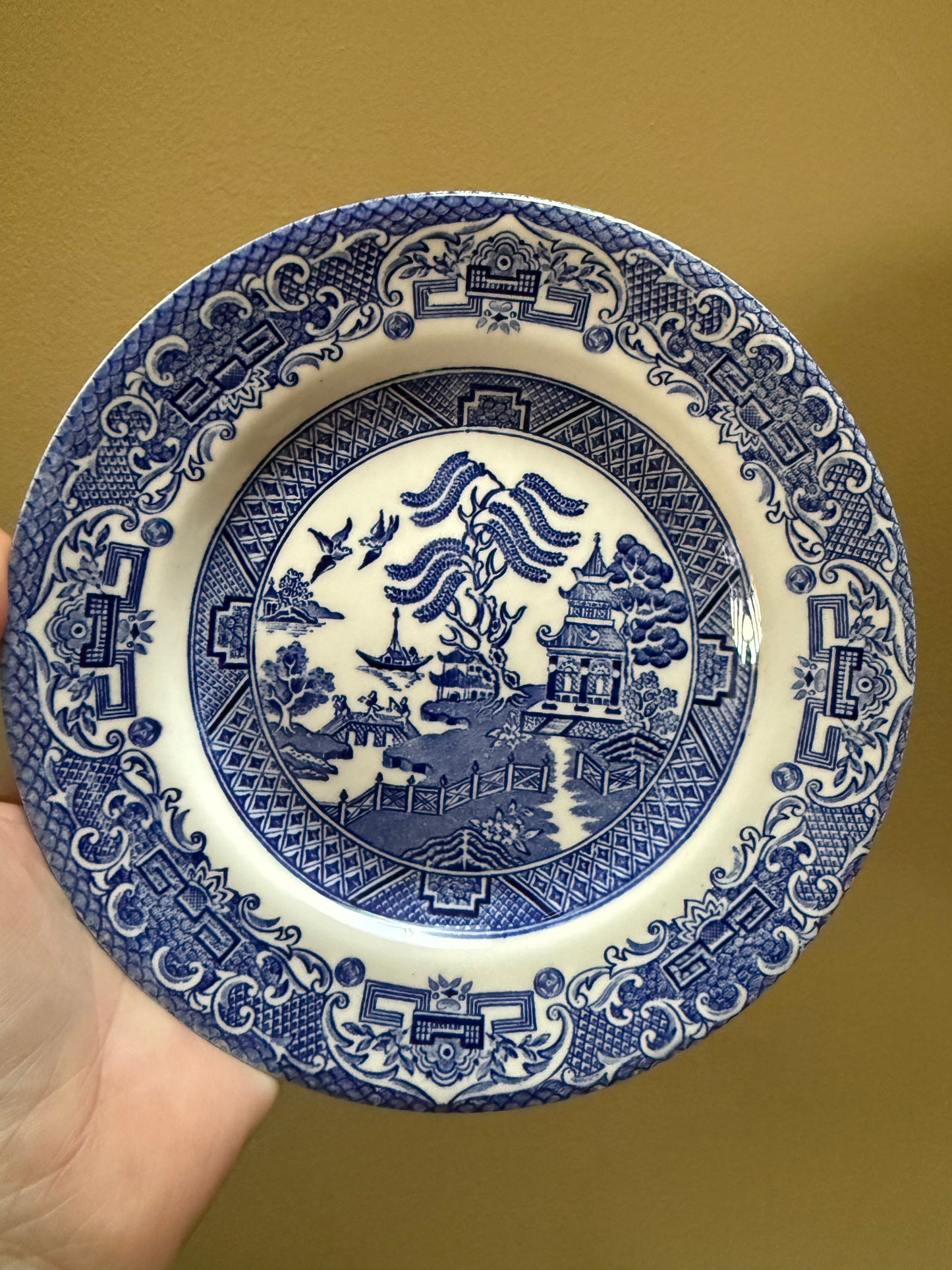 Set of six vintage Blue Willow pattern side plates in classic blue and white.