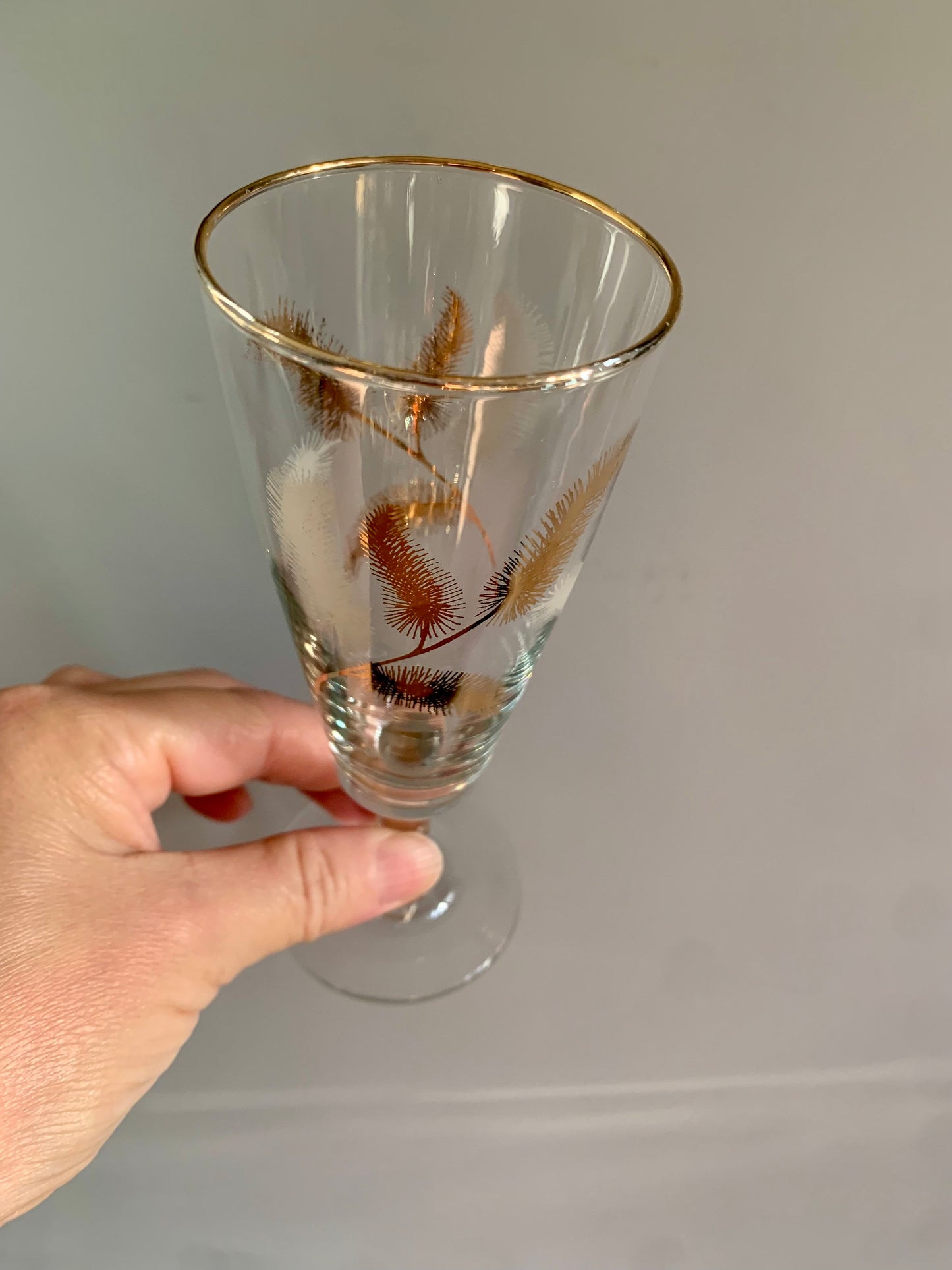 Vintage, gold feather stemmed glasses.