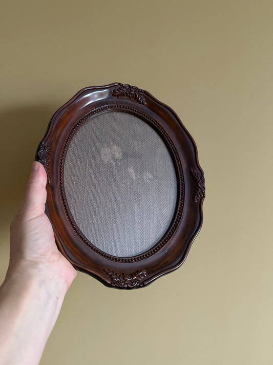 Vintage, oval plastic frame.