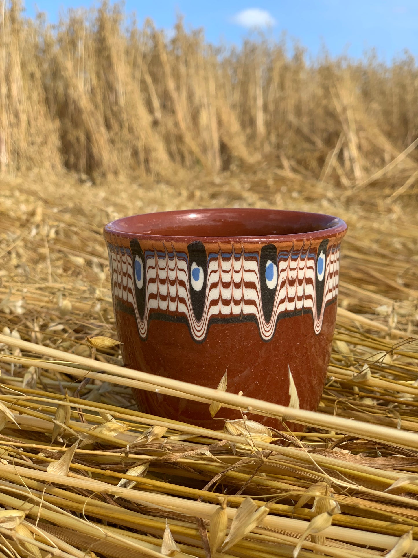 Hand thrown and hand painted, ceramic cups.