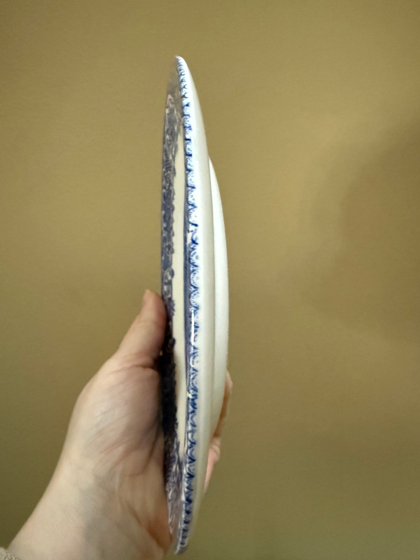 Set of six vintage Blue Willow pattern side plates in classic blue and white.