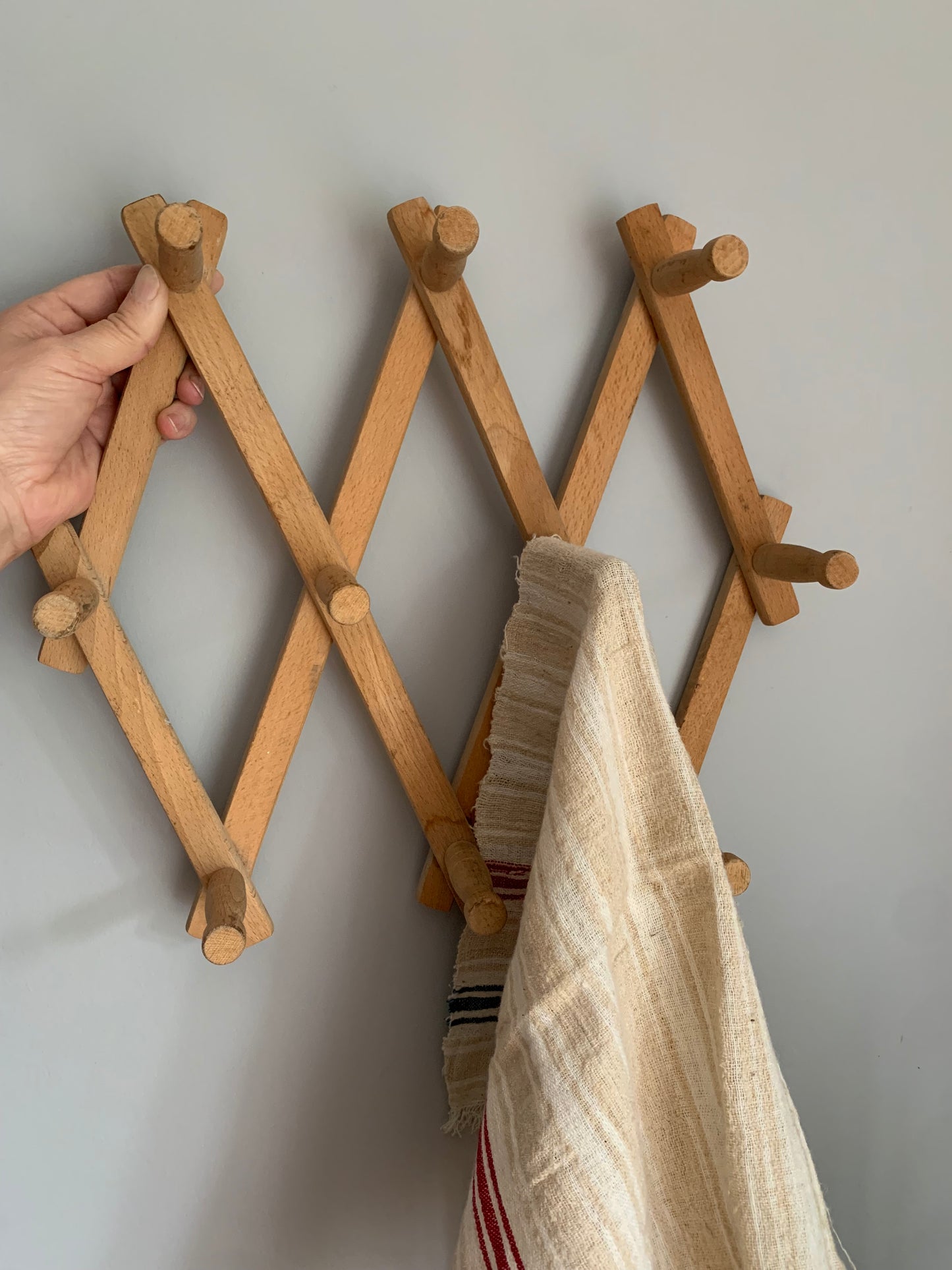 Vintage, wood expandable wall rack.